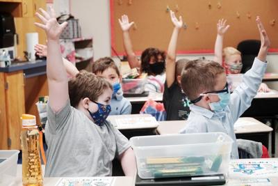 First graders raise their hands (copy)