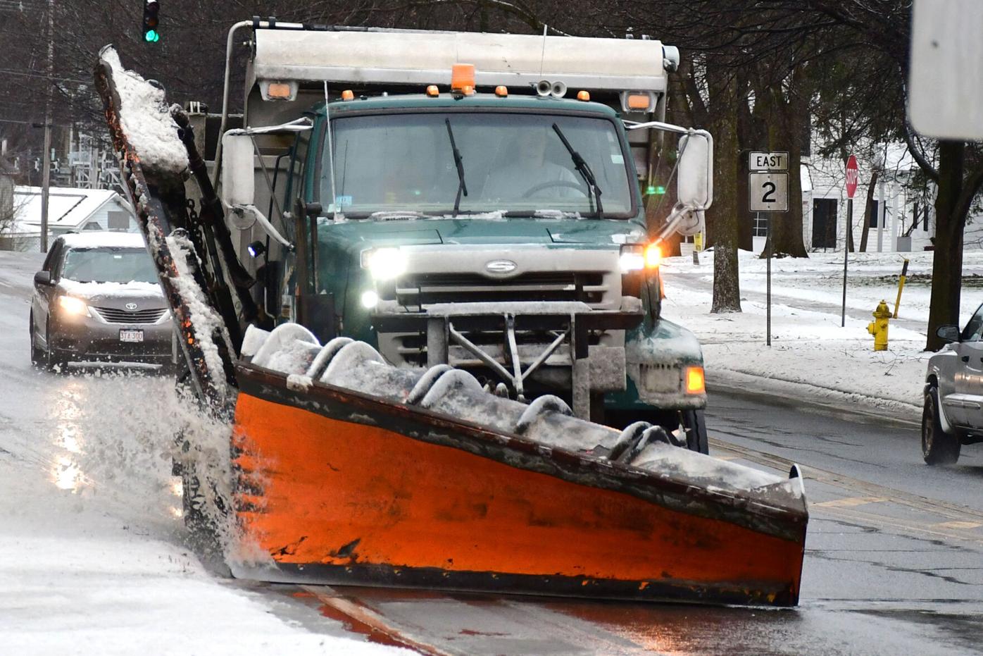 A snowplow clears wet snow