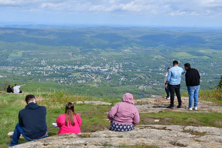 People look at the view from the summit
