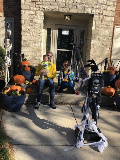 Family chutes treats for visitors on Halloween