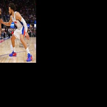 Detroit's Cade Cunningham (right) marks Cleveland's James Harden in the Pistons' series-opening win over the Cavaliers