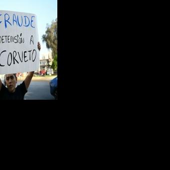 A man holds a banner reading “Fraud, arrest Corvetto” (referring to Peru’s National Office of Electoral Processes chief, Piero Corvetto) outside the National Office of Electoral Processes (ONPE) in Lima on April 12, 2026, during the general…