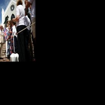 King Charles greeted a line of schoolchildren, pausing to chat with them, on the steps of the whitewashed St. Peter's...