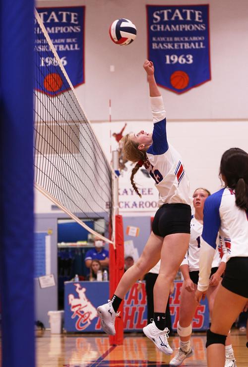 Tinley Pierson stretches backwards to punch the ball over the net during a long volley