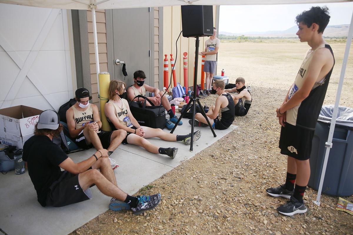 Members of Buffalo High School’s boys cross country team huddled in the shade