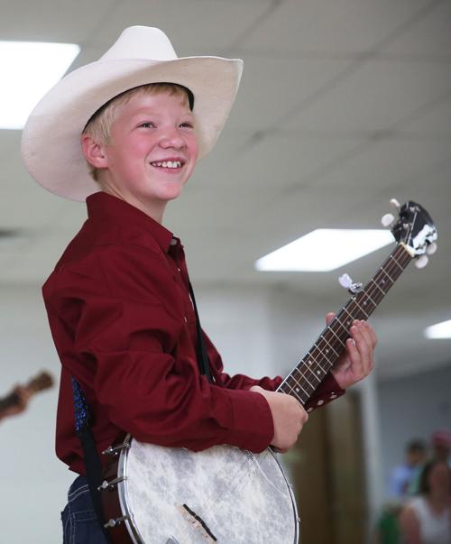 Sean Gose, laughs as his group performs a song