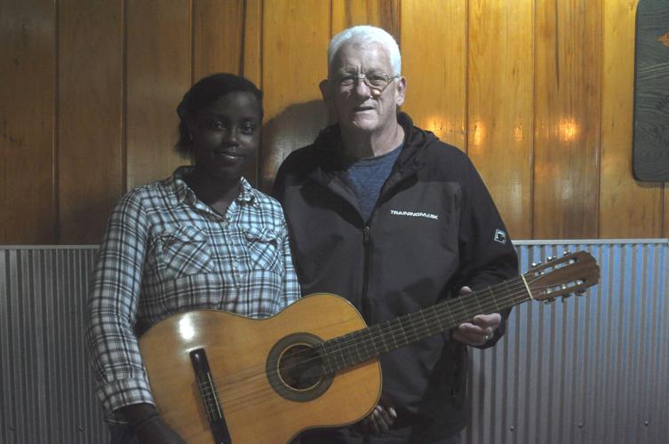 Chance encounter leads to Tustin woman from Haiti receiving guitar with incredible backstory