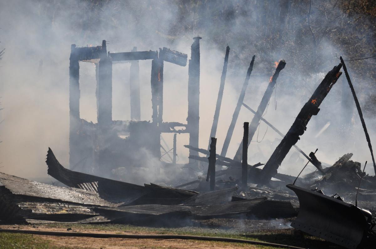 Structure destroyed by fire east of Manton