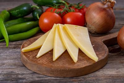 Gruyere cheese on wood background