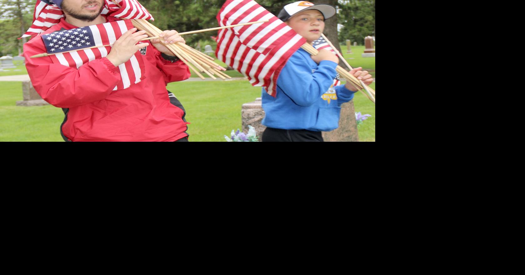 Volunteers place flags for Memorial Day | Multimedia | carrollspaper.com