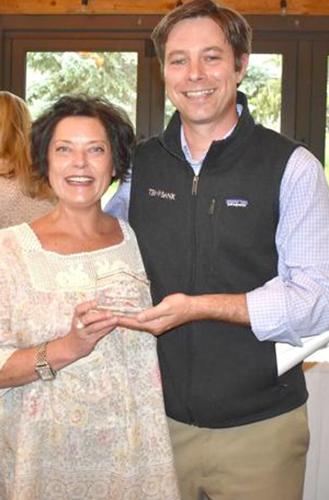 Habitat for Humanity chairman Dustin Nichols presents Catherine Fisher with an award