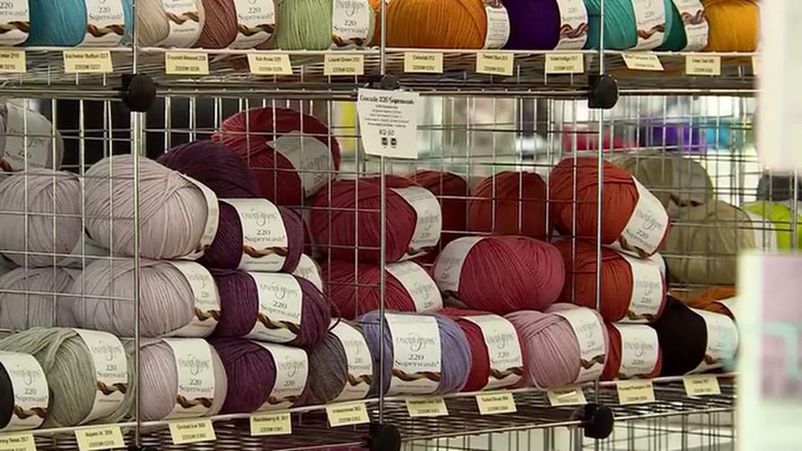 Family combines two beloved yarn shops divided by tape line, reopens as ...