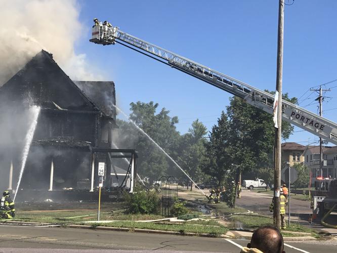 Multiple crews respond to large house fire in Portage, people asked to
