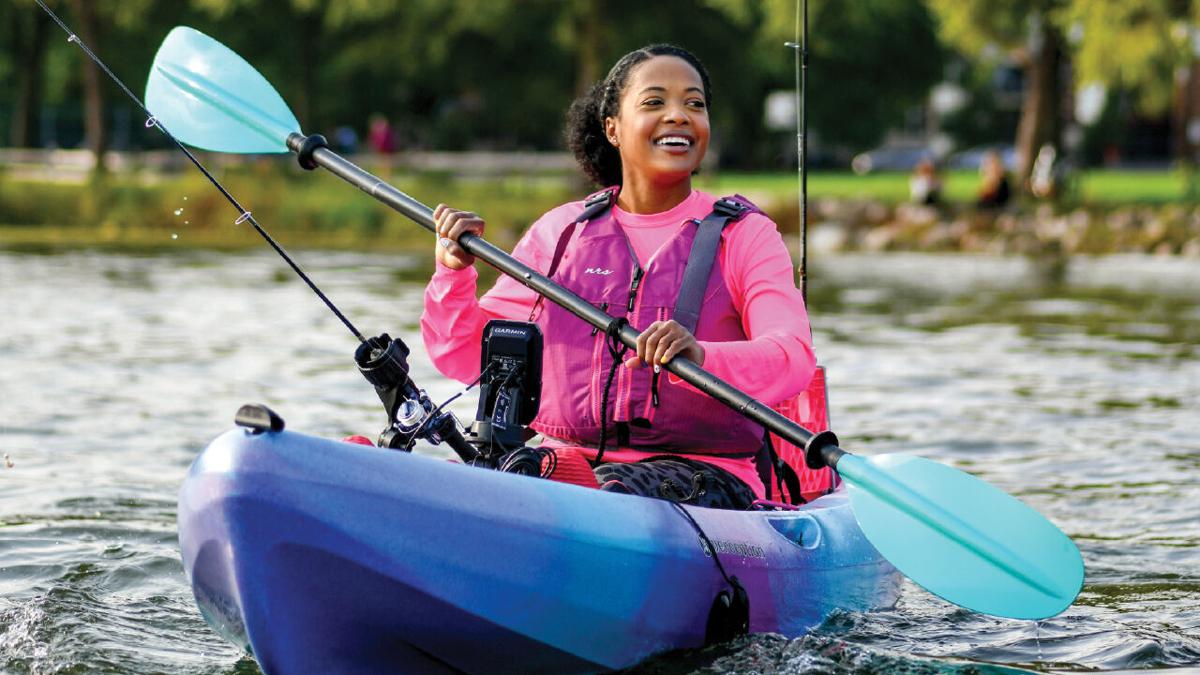 Ashley Anderson reels on the water when kayak-fishing, City Life