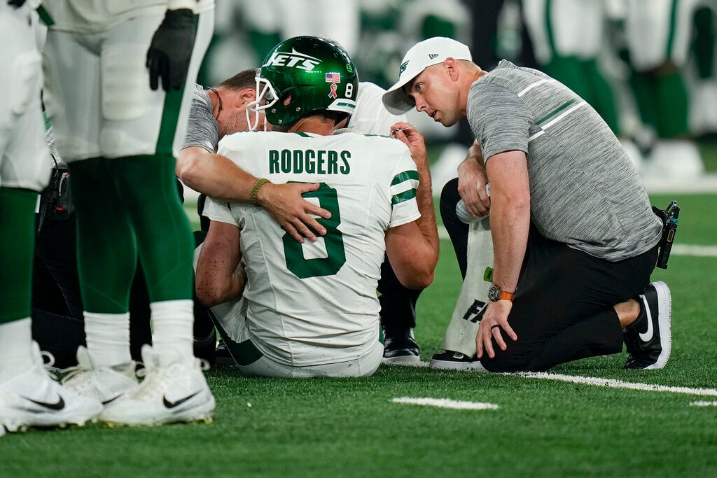 Aaron Rodgers injures his left Achilles tendon in his first series for the  Jets, Green Bay Packers