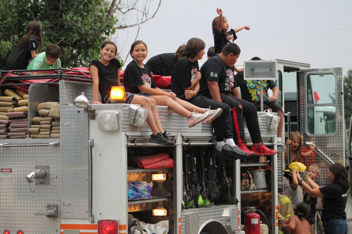 Children crowd onto the fire truck