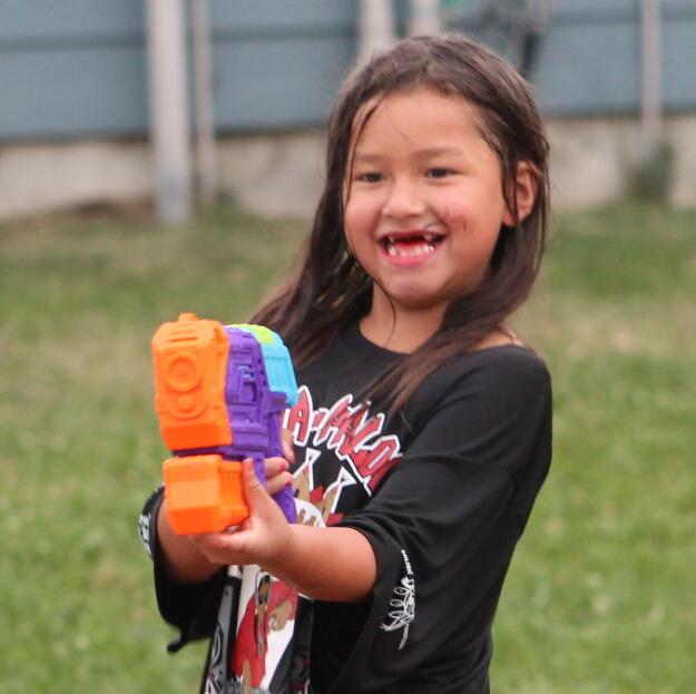 The children have a great time drenching each other