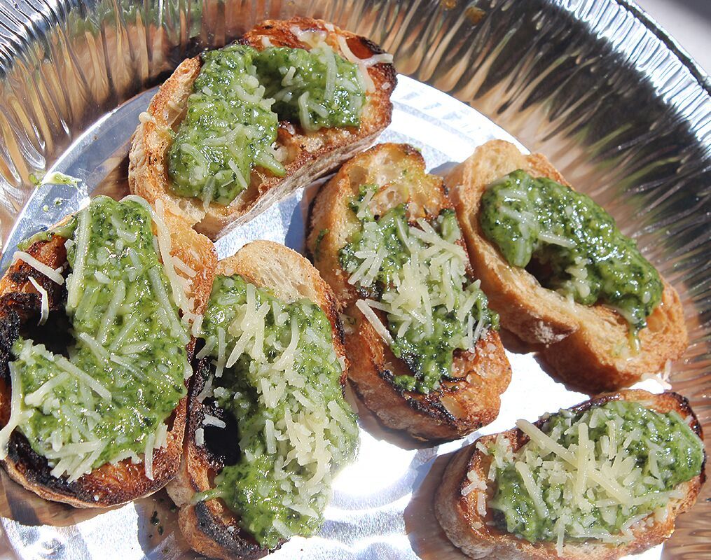 Baguette slices topped with fresh basil pesto