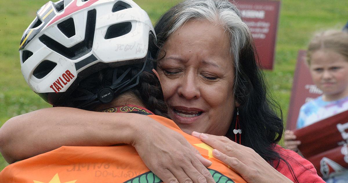 Proud Cherokee families, friends embrace returning cyclists