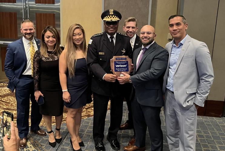 Chicago Police Department Superintendent David O. Brown holds award presented to Verizon for its support of the CPD at True Blue Event.