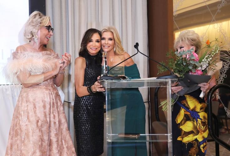 Tracey DiBuono is presented with the Hood/Swift Woman with FLAIR award from Sherry Lea Holson, last year's honoree and co-chair, along with co-chairs Sheree Schimmer and Sherrill Bodine. (Photo by Mila Samokhina)