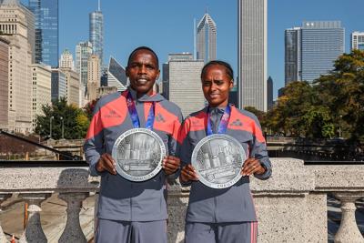 Amos Kirpruto, men's winner, with Hawi Feysa, who defended her woman's crown. (Photo © Bank of America Chicago Marathon/Kevin Morris)