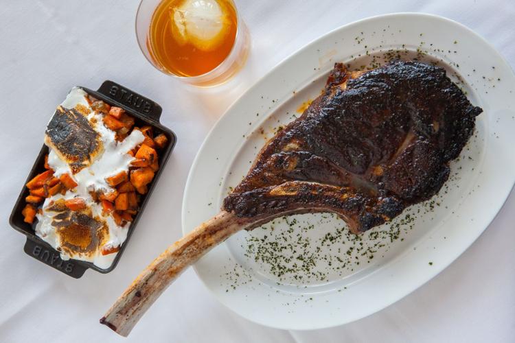 Mishima Reserve Wagyu Tomahawk Chop, with roasted sweet potatoes. (Photo by Shannon O'Hara for Steak 48)