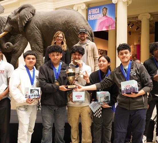 NASCAR's Julie Giese and driver Ray Blaney congratulate winning students at 3rd annual STEAM Fest Design Challenge. (NASCAR Chicago Street Race photo)