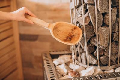 Spoon with cold water in sauna