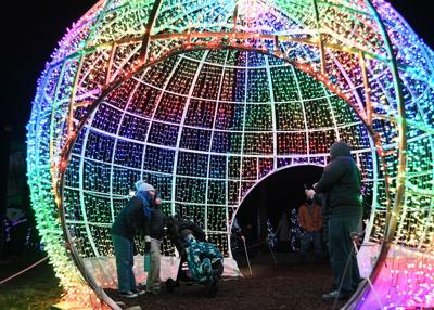 Inside a giant glowing orb is the perfect place to take a memorable photo of a visit to Brookfield Zoo during Holiday Magic®.
