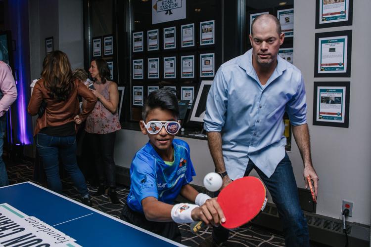 Sean Marshall (team Cubs) with Nanden Naresh, table tennis master, at 2017 Ping Pong Ball.