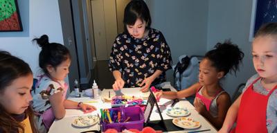 Designer Michelle Kim leads a Fashion Design class for neighborhood kids in the New Eastside. Photo submitted by Michelle Kim.
