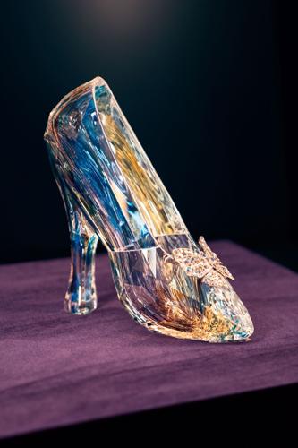 Glass slipper from the live-action Cinderella (2015) on display in the Where Do the Stories Come From gallery at Disney100: The Exhibition. (Photo courtesy of © Disney)
