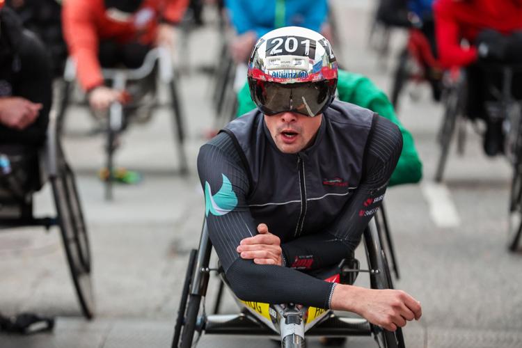 Marcel Hug won the men’s wheelchair race, shattering his own course record by nearly three minutes, winning his fourth Bank of America Chicago Marathon in 1:22:37. (Photo courtesy of Chicago Marathon, by Kevin R. Morris)