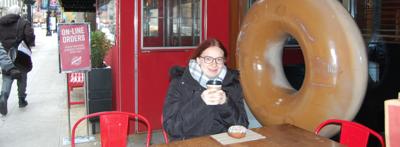 Abigail Manville enjoys a freshly baked gluten free donut from Do Rite Donuts in the Loop. Photo by Angela Gagnon