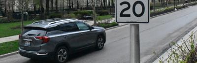 A car passes a new 20 mile per hour sign on East Benton Place. Photo by Jesse Wright