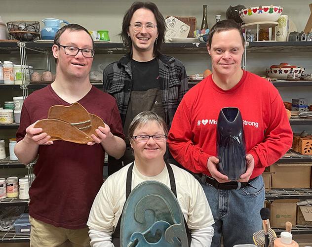 Misericordia residents and instructor with their beautiful artwork.
