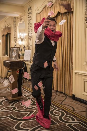 Capping off the evening, Dennis performs a signature piece – an outrageous card trick with a giant balloon