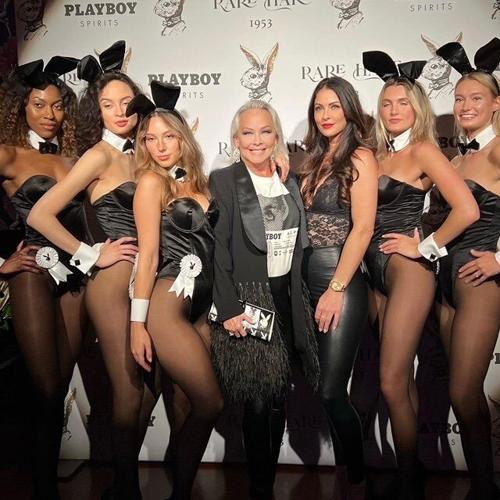 Surrounded by model Bunnies. Playboy will always be family to me. Thanks for the memories Hef.