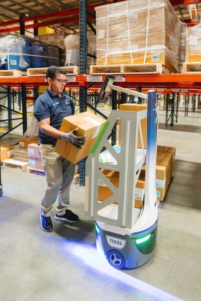 An EVERSANA team member works in the company's new distribution center using robotics technology.