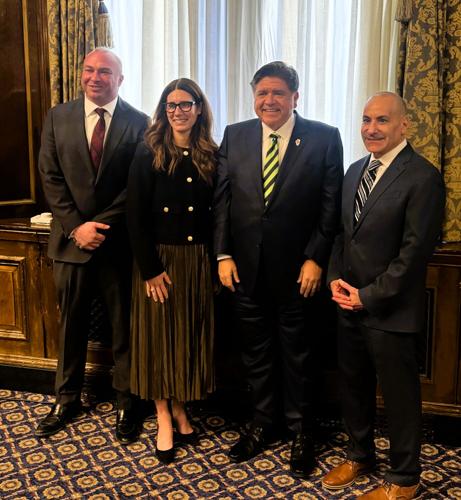 Governor Pritzker congratulates Liz Lombardo Stark with Sam Toia (R) and Scott Weiner, outgoing chair.