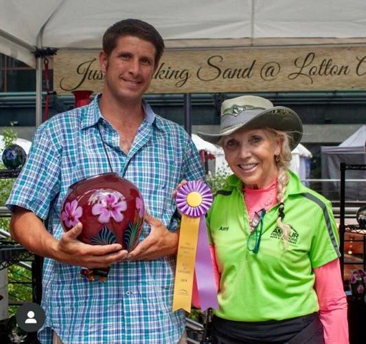 Amdur Productions founder Amy Amdur, with Robert Lagestee of Lotton Art Glass. (2024 Millennium Art Festival, photo Candace Jordan)