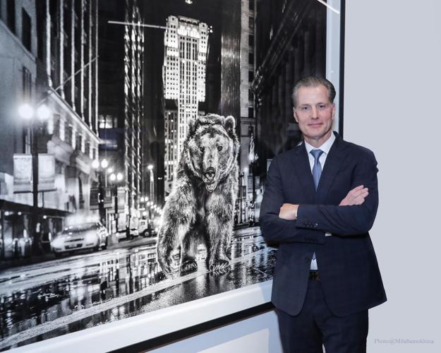 Bears Coach Matt Eberflus stands beside photo by David Yarrow at ALS United Greater Chicago fundraiser at the Hilton Contemporary Gallery after receiving the Iron Horse Award. . (Photo by Mila Samokhina)