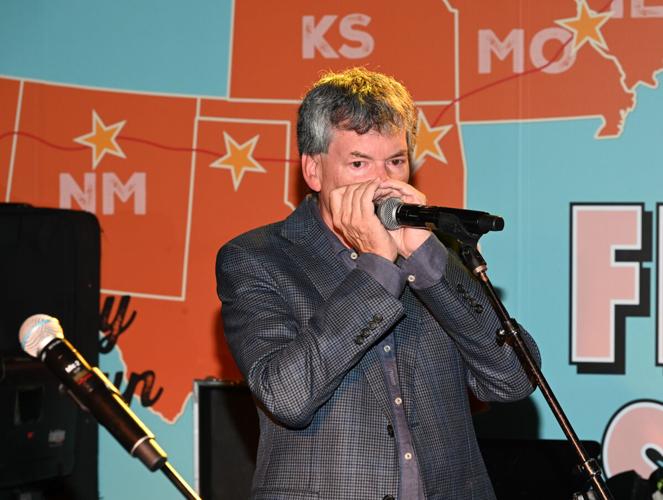 Alderman Brian Hopkins joined the Dr. Bombay band on the harmonica. (Jeff Brown photo)