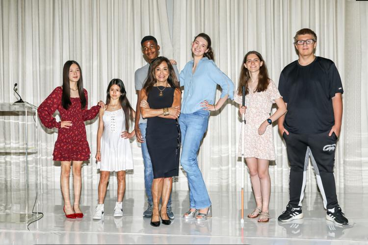 Tracey Tarantino DiBuono (co-event host, ZZAZZ Productions) poses with Chicago Lighthouse Youth Transition Program models. (Photo by Mila Samokhina)