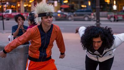 A cosplayer dressed as Naruto (left) runs around Trump Tower in 2017.