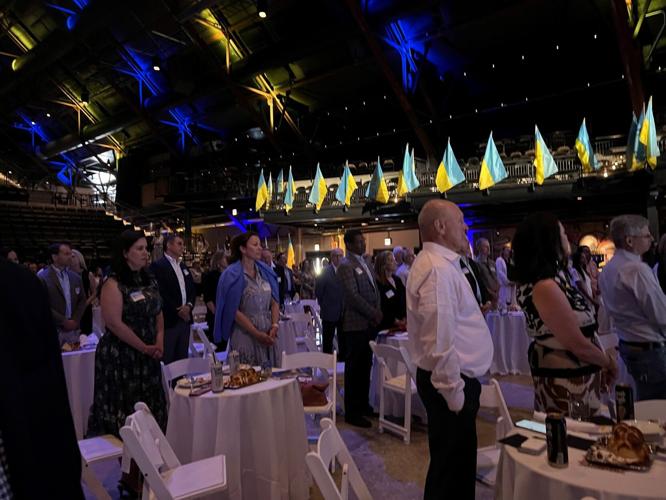 Guests stand during the singing of the Ukrainian national anthem by Lyric Opera's Marianna Kulikova.