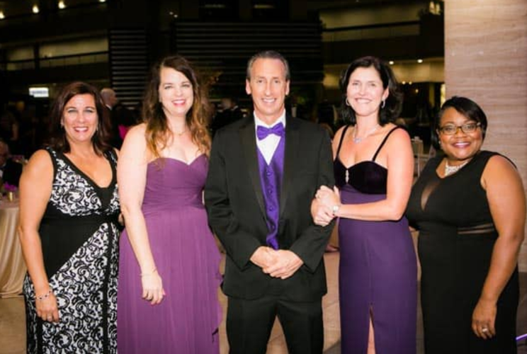 Rebecca Darr (2nd from R, ED of WINGS) celebrating 2019 Purple Tie Ball with friends.