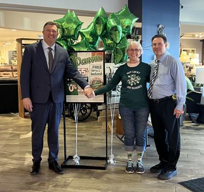 Will Harris, president Darvin Furniture & Mattress (L), congratulates Oak Park resident Barbara Cusack for winning a deluxe trip to Ireland through the company's St. Patrick's Day promotion. Sales associate Ron Schmitt on right.