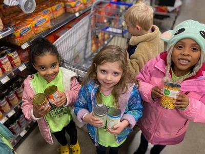 Students from Primrose School of Reynoldsburg (Columbus, OH) visit a local grocery store to shop for items to donate during the annual Caring and Giving Food Drive.